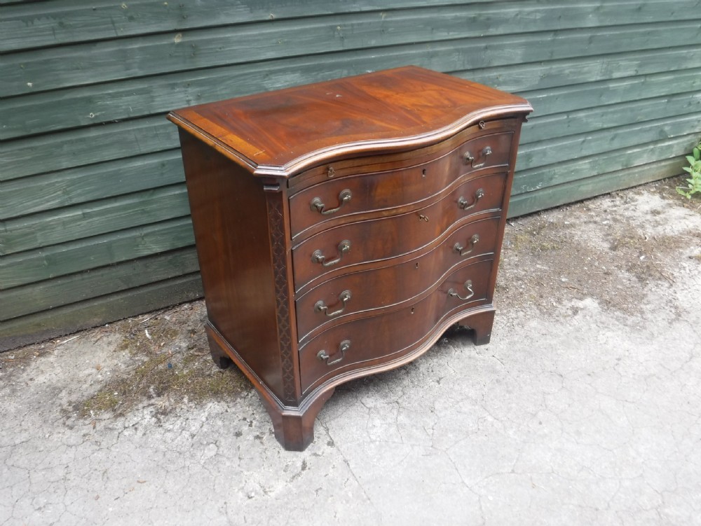 Small early 20th century serpentine front mahogany chest View III