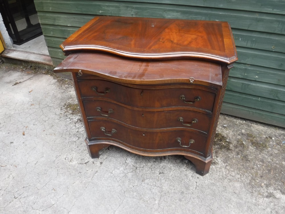 Small early 20th century serpentine front mahogany chest View IV
