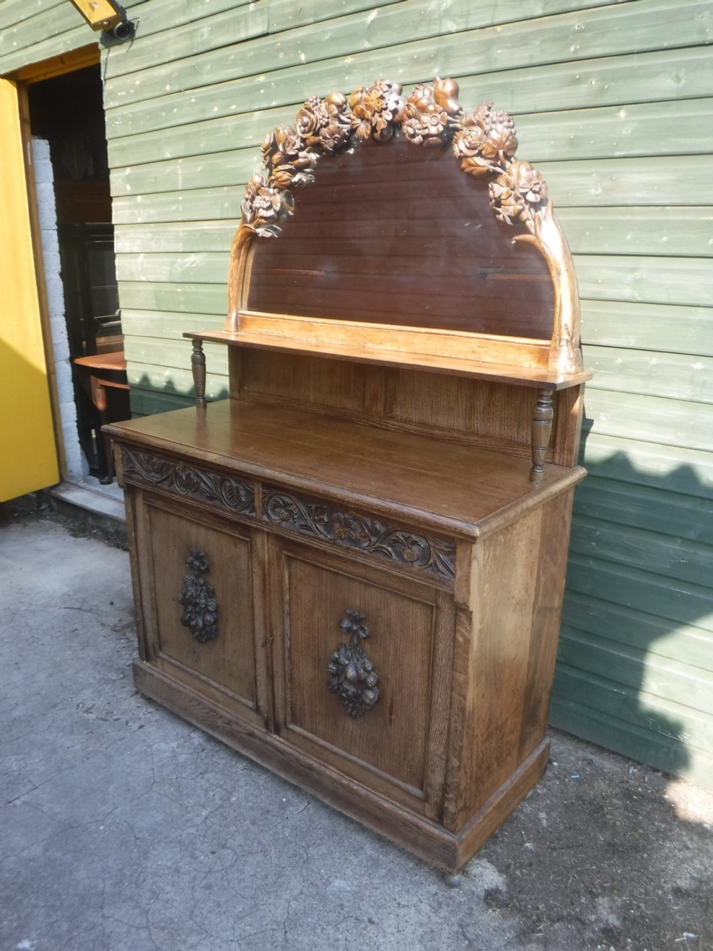 Lovely and unusual neat carved oak mirror backed side cabinet
