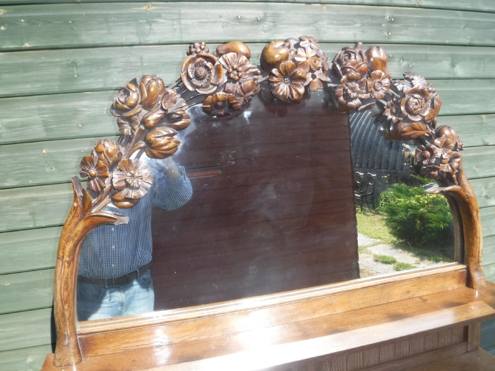 Lovely and unusual neat carved oak mirror backed side cabinet View II