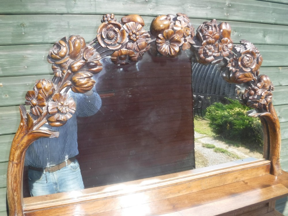 Lovely and unusual neat carved oak mirror backed side cabinet View V