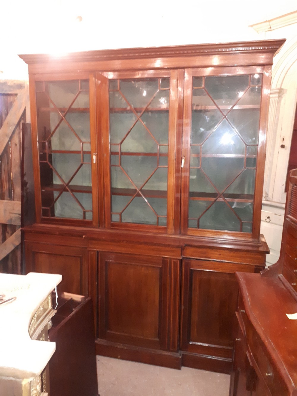 Edwardian inlaid mahogany breakfront bookcase. 