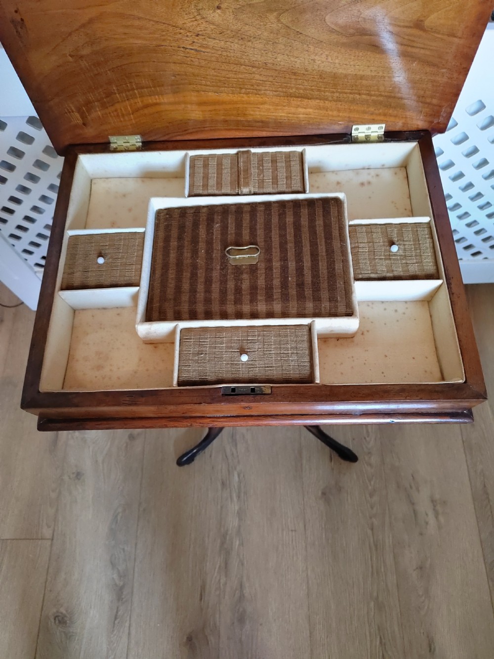 A Victorian wooden trumpet sewing table with an inlaid top, fretwork column, and carved tripod base. View VIII
