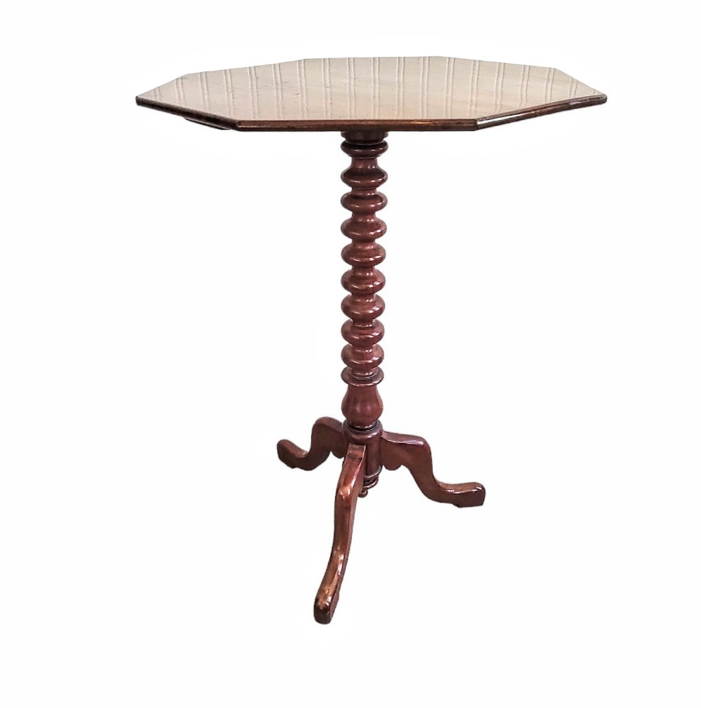 A 19th-century mahogany wine table featuring an octagonal top supported by a central bobbin-turned column and a three-legged tripod base.