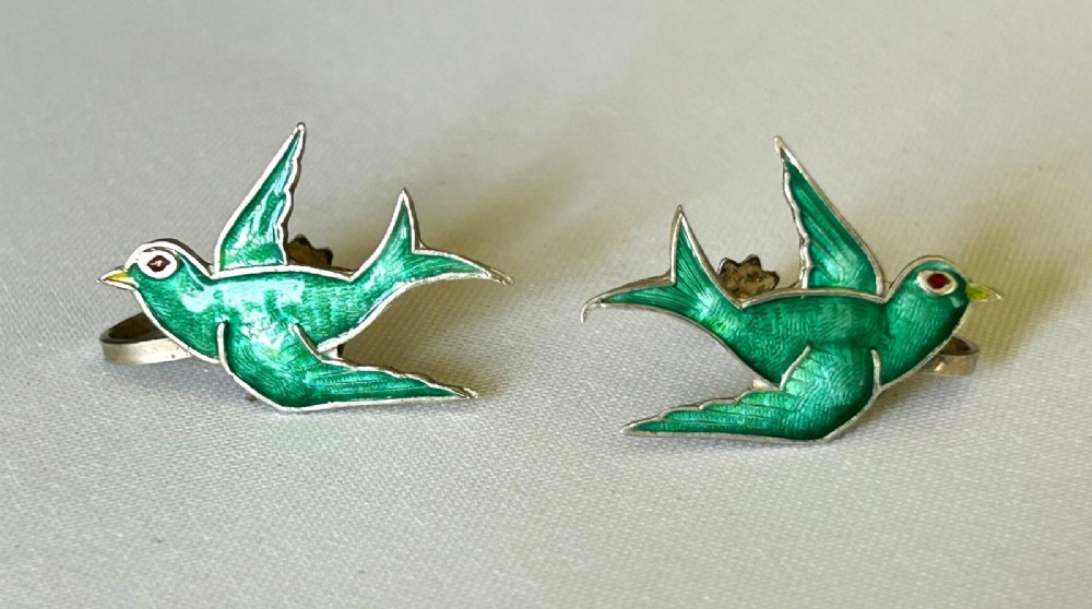 Pair of Edwardian sterling silver earrings shaped as swallows in flight with vibrant green enamel wings and body. View IV