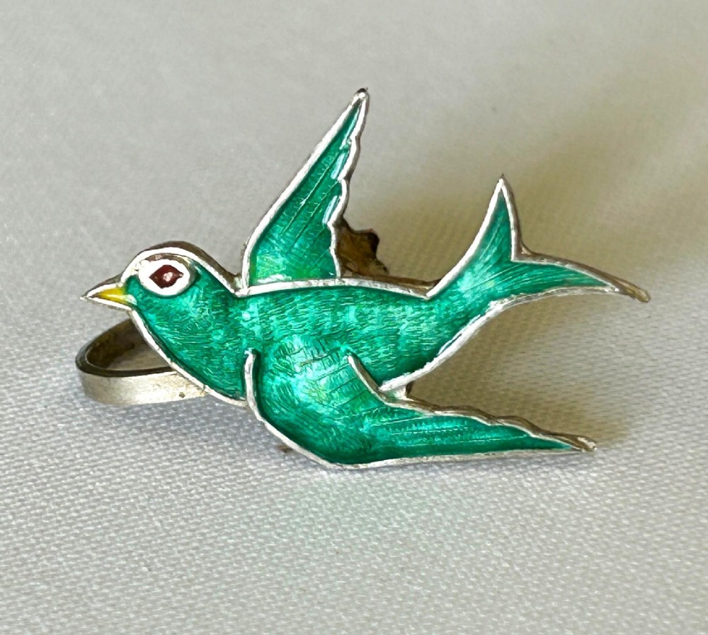Pair of Edwardian sterling silver earrings shaped as swallows in flight with vibrant green enamel wings and body. View V