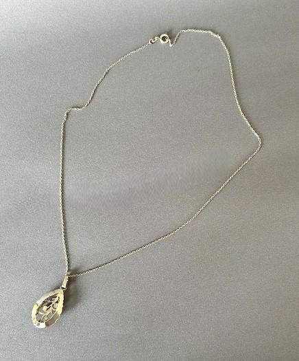 A teardrop-shaped silver pendant featuring textured edges, openwork branch motifs, and three small green chrysoprase cabochons suspended on a fine silver chain. View VII