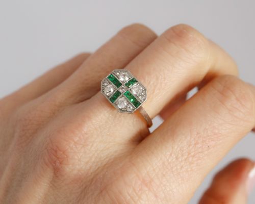 fig 5. An Art Deco rectangular plaque ring featuring a cross motif of green emeralds surrounded by four round diamonds set in platinum on a gold band.