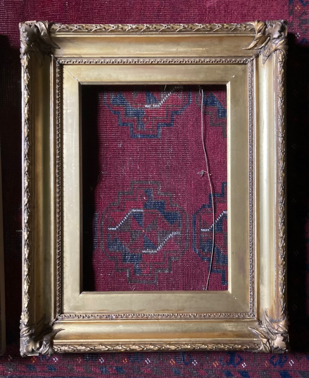 A matching pair of rectangular antique gilt gesso picture frames featuring ornate corner carvings and leaf motif mouldings. View II