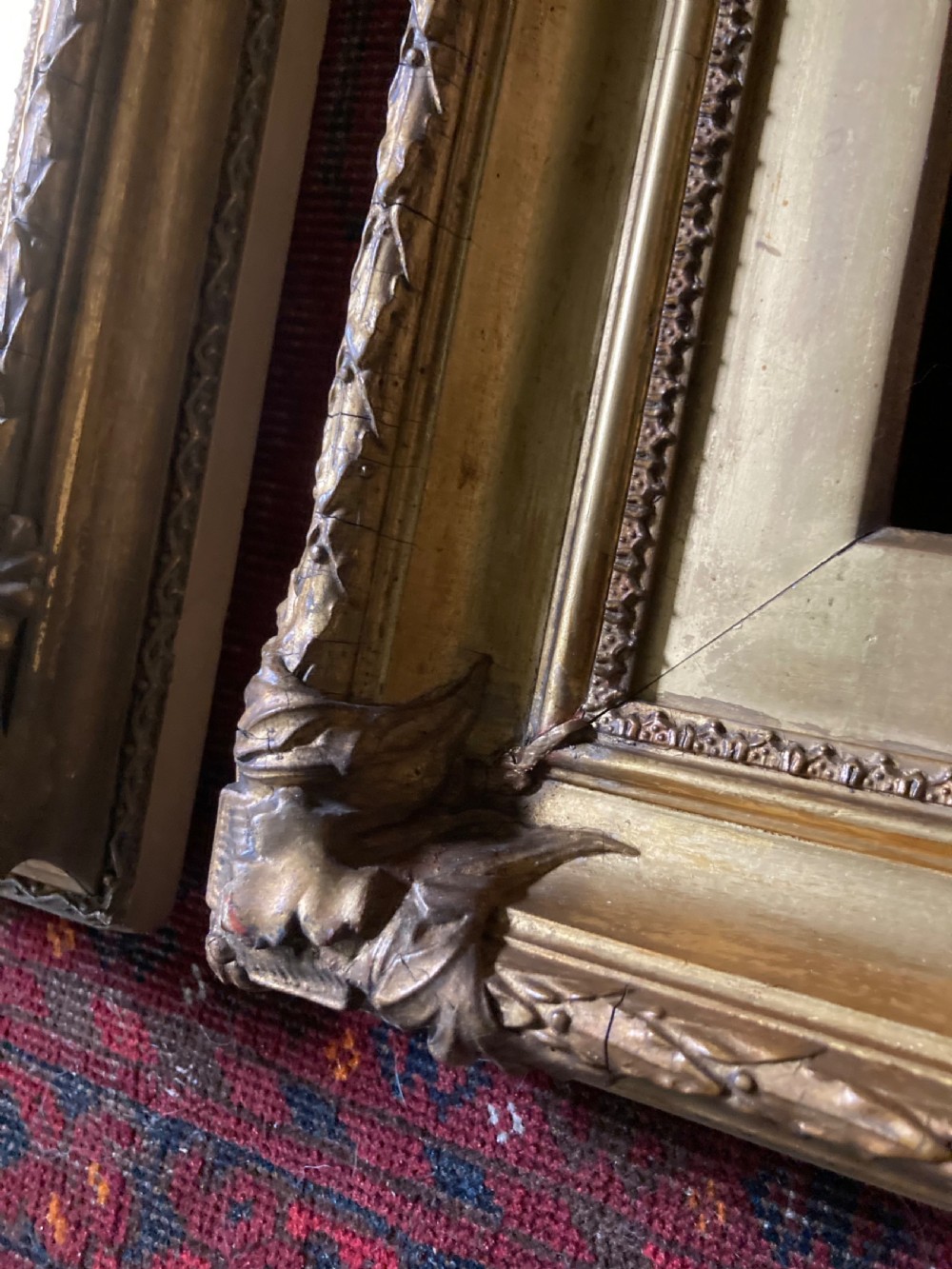 A matching pair of rectangular antique gilt gesso picture frames featuring ornate corner carvings and leaf motif mouldings. View VI