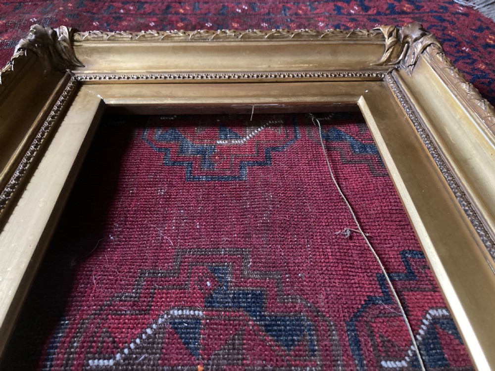 A matching pair of rectangular antique gilt gesso picture frames featuring ornate corner carvings and leaf motif mouldings. View VIII