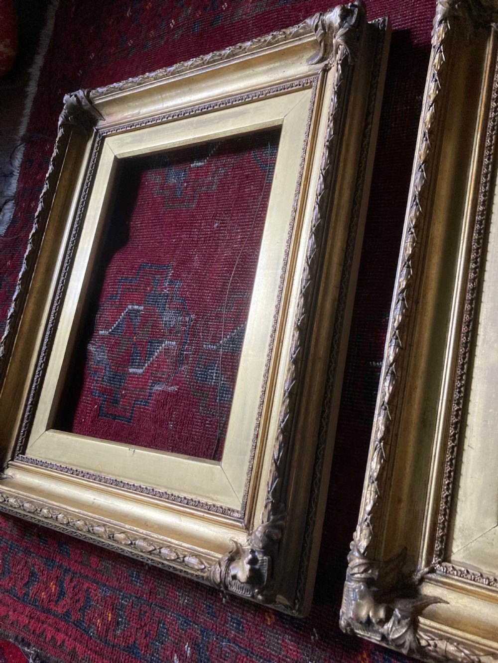 A matching pair of rectangular antique gilt gesso picture frames featuring ornate corner carvings and leaf motif mouldings. View X