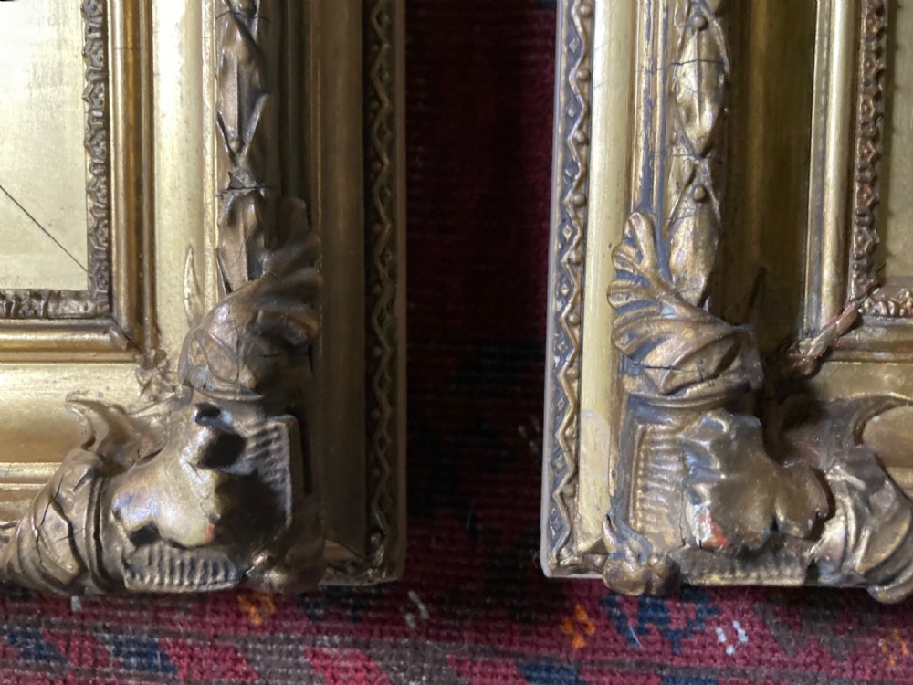 A matching pair of rectangular antique gilt gesso picture frames featuring ornate corner carvings and leaf motif mouldings. View XII