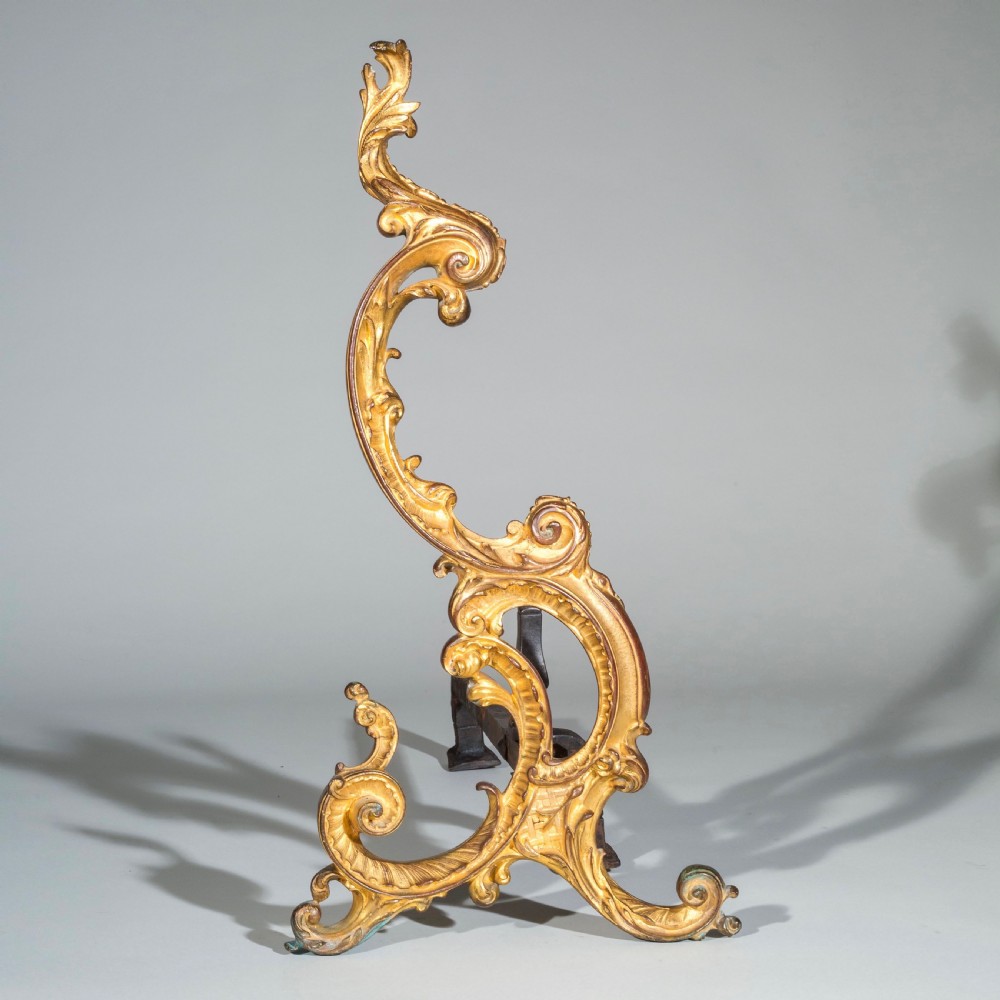 A pair of 18th-century gilt bronze Rococo andirons featuring swept C-scrolls, acanthus leaf carving, and iron rear billet bars. View IV