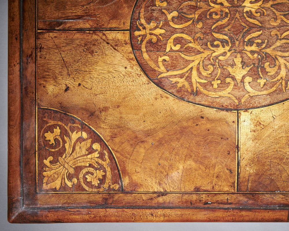 A rectangular seventeenth-century figured walnut box featuring intricate seaweed marquetry in an oval central cartouche and matching corner panels. View V