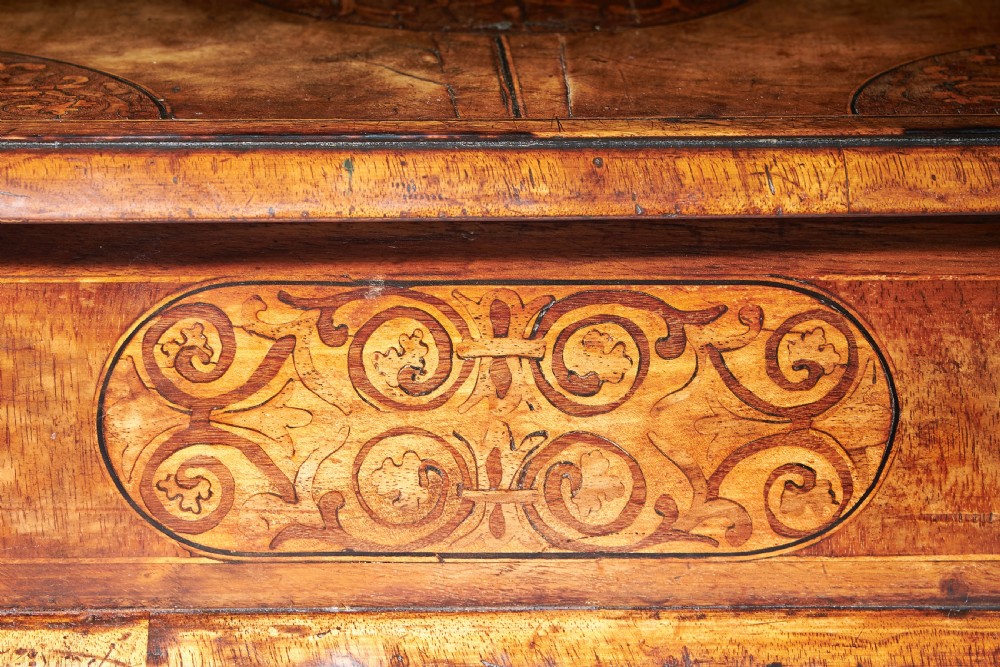 A rectangular seventeenth-century figured walnut box featuring intricate seaweed marquetry in an oval central cartouche and matching corner panels. View XII
