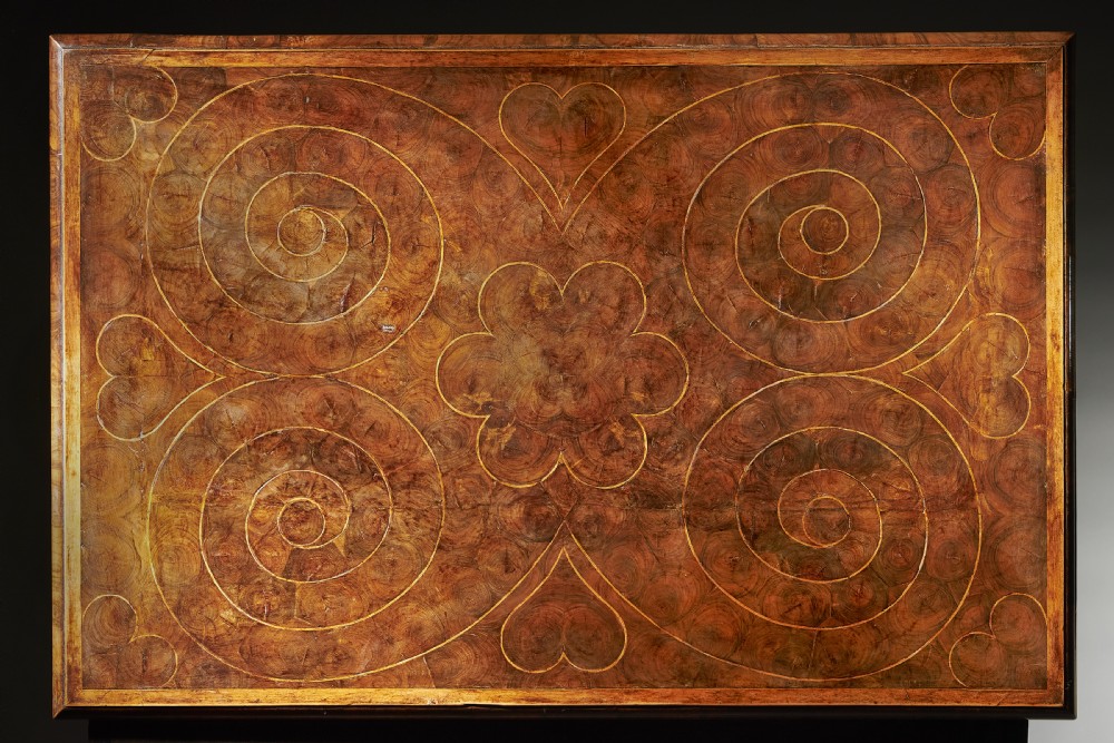 A late 17th-century William and Mary olive wood chest on stand featuring oyster veneering, stringing, brass escutcheons, and barley twist legs. View XVIII
