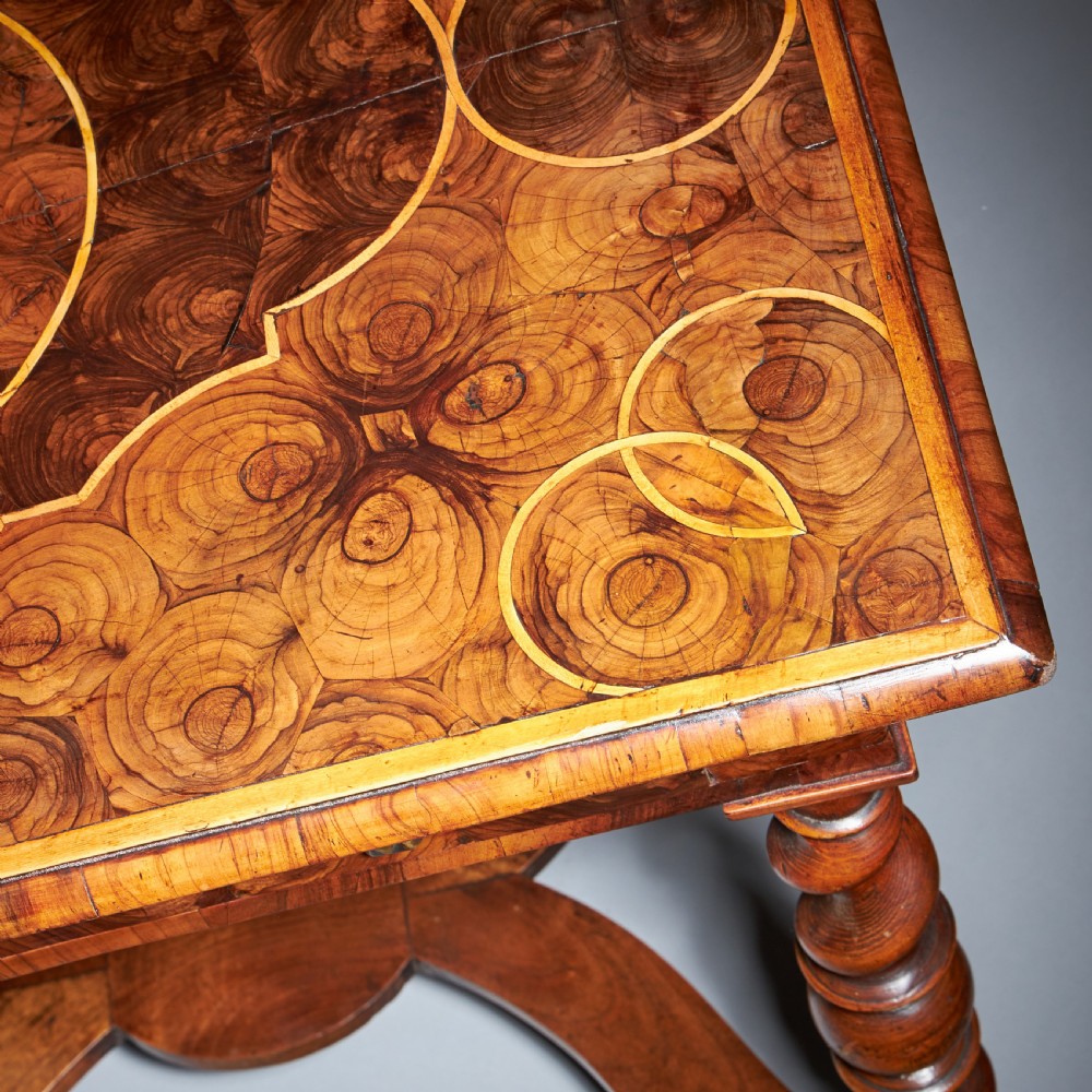 A late 17th-century William and Mary side table featuring intricate olive wood oyster veneering, barley-twist legs, an X-frame stretcher, and a frieze drawer. View VI