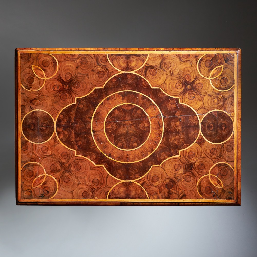 A late 17th-century William and Mary side table featuring intricate olive wood oyster veneering, barley-twist legs, an X-frame stretcher, and a frieze drawer. View VII