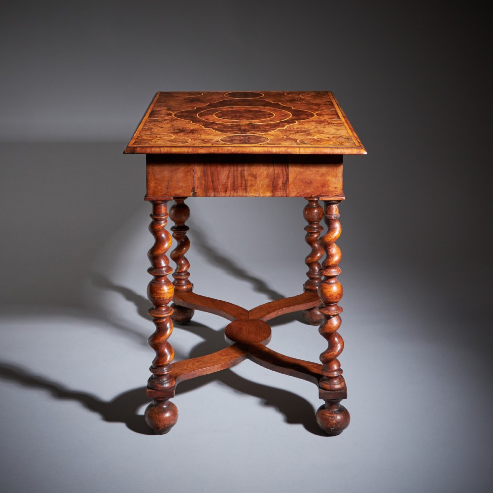 A late 17th-century William and Mary side table featuring intricate olive wood oyster veneering, barley-twist legs, an X-frame stretcher, and a frieze drawer. View VIII