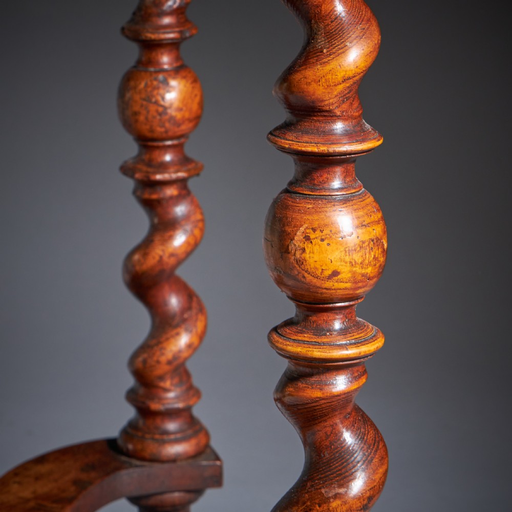 A late 17th-century William and Mary side table featuring intricate olive wood oyster veneering, barley-twist legs, an X-frame stretcher, and a frieze drawer. View X