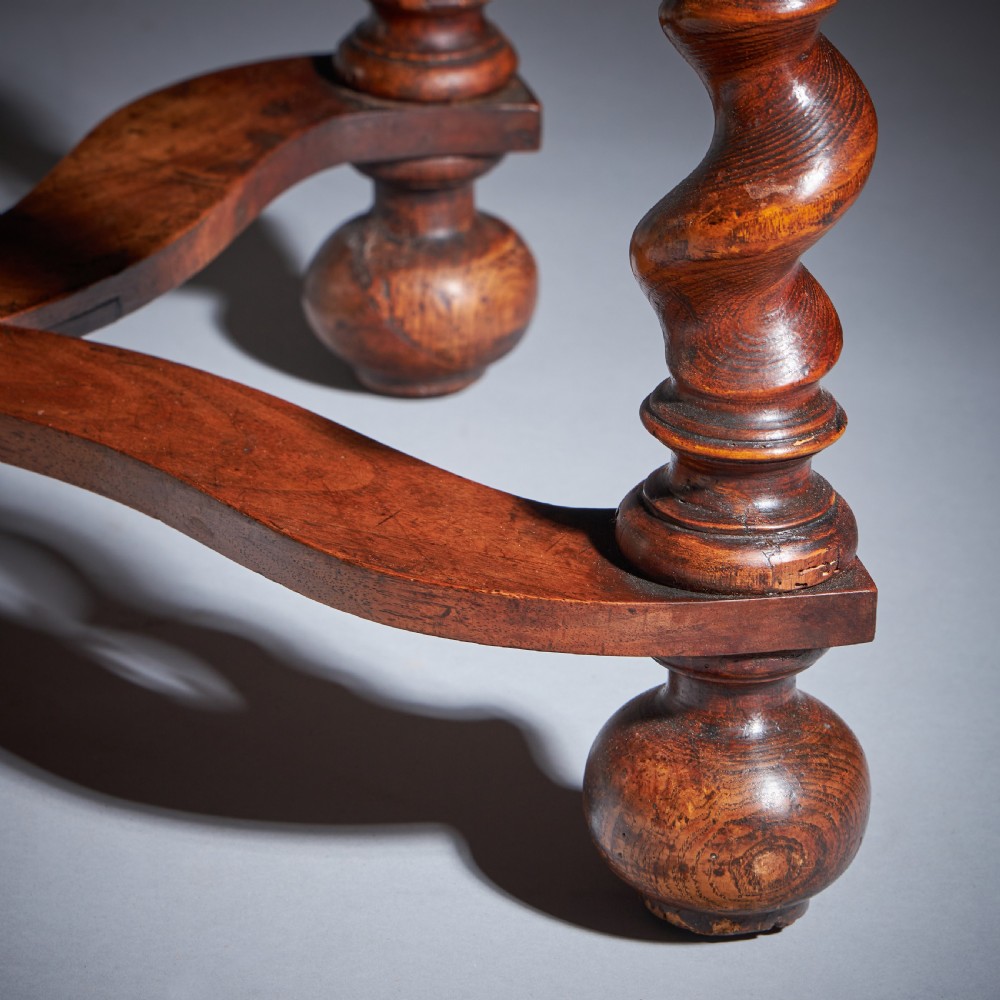 A late 17th-century William and Mary side table featuring intricate olive wood oyster veneering, barley-twist legs, an X-frame stretcher, and a frieze drawer. View XI