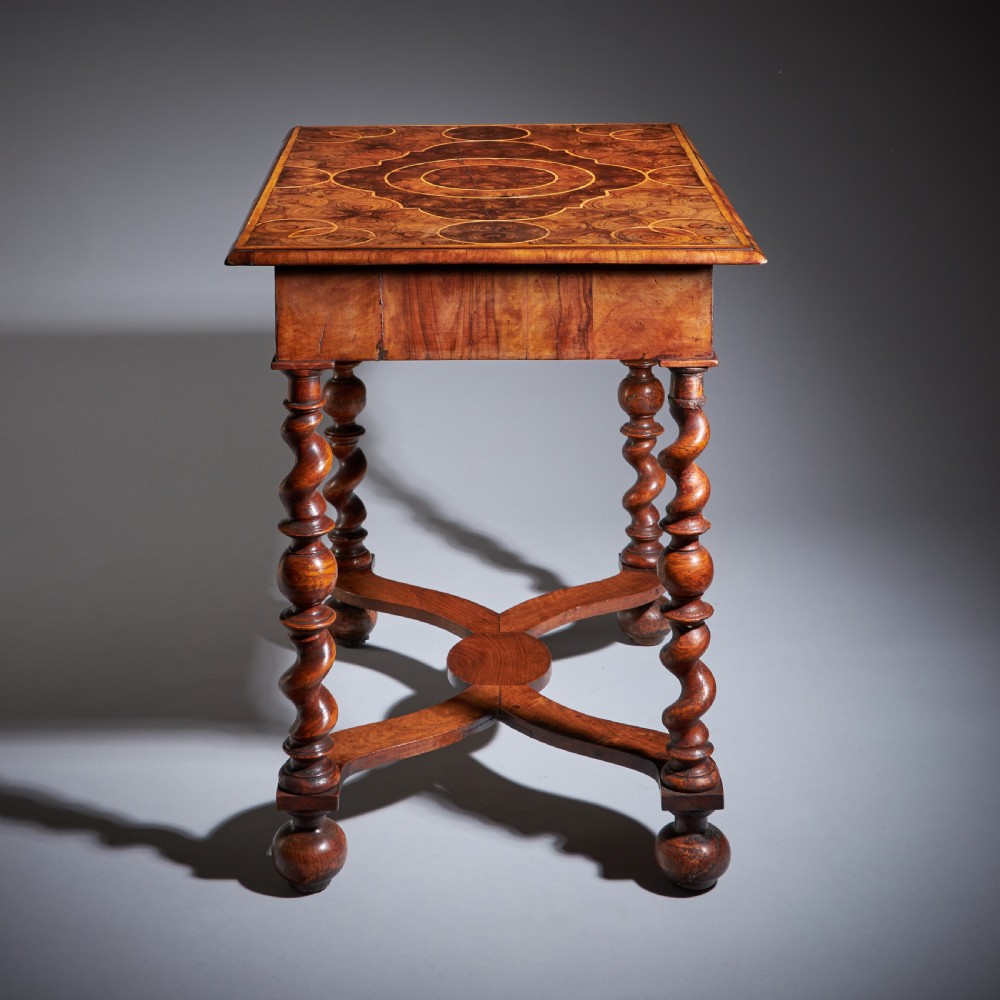 A late 17th-century William and Mary side table featuring intricate olive wood oyster veneering, barley-twist legs, an X-frame stretcher, and a frieze drawer. View XIII