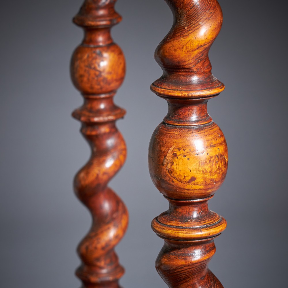 A late 17th-century William and Mary side table featuring intricate olive wood oyster veneering, barley-twist legs, an X-frame stretcher, and a frieze drawer. View XV