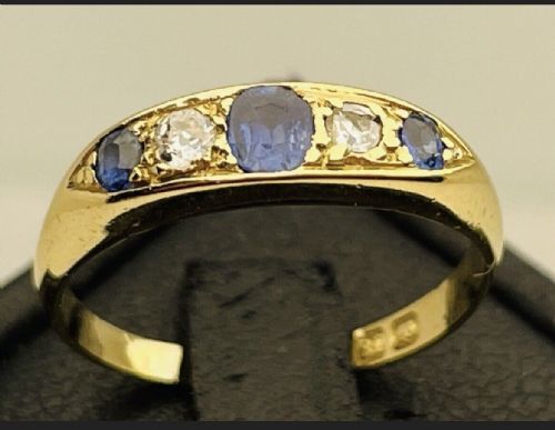 fig 1. An Edwardian 18ct yellow gold ring set with three blue sapphires alternating with two white diamonds in a carved bridge setting.