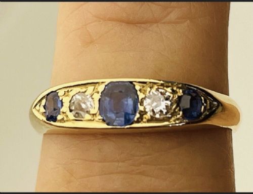 fig 2. An Edwardian 18ct yellow gold ring set with three blue sapphires alternating with two white diamonds in a carved bridge setting.
