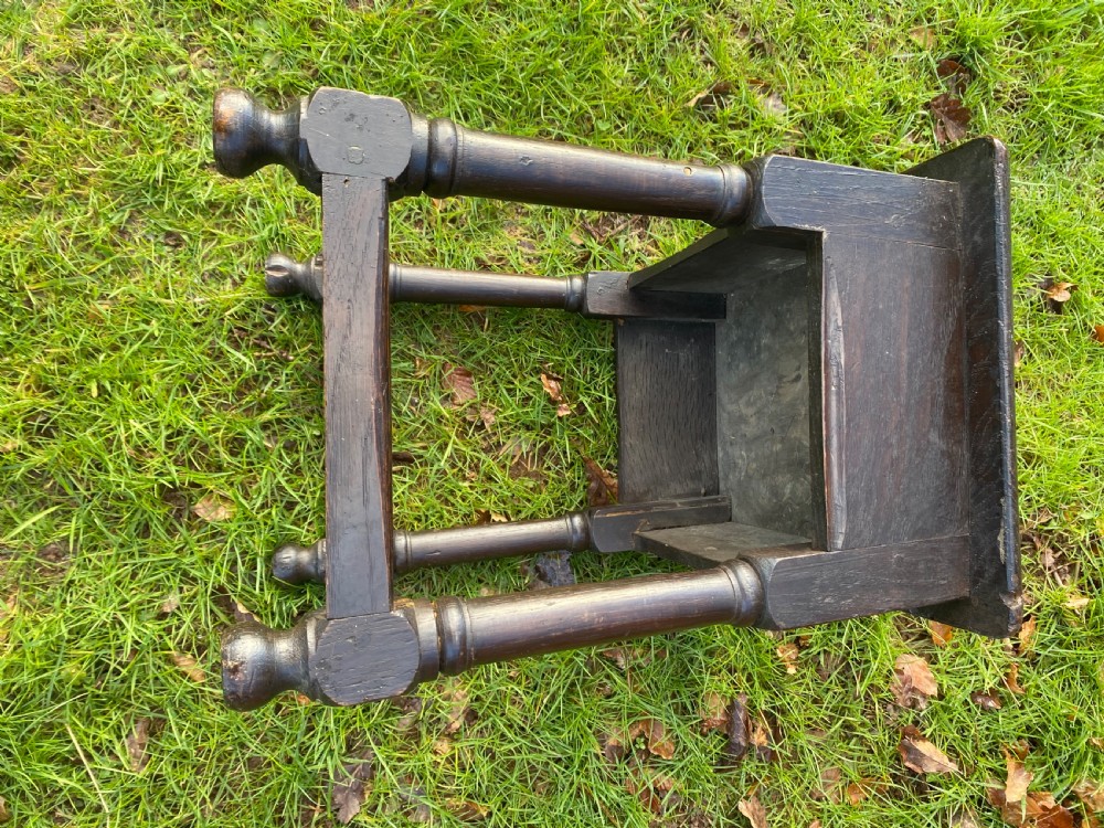 A dark oak joint stool featuring a rectangular top, rectangular frame apron, four turned legs, and low perimeter stretchers. View VIII