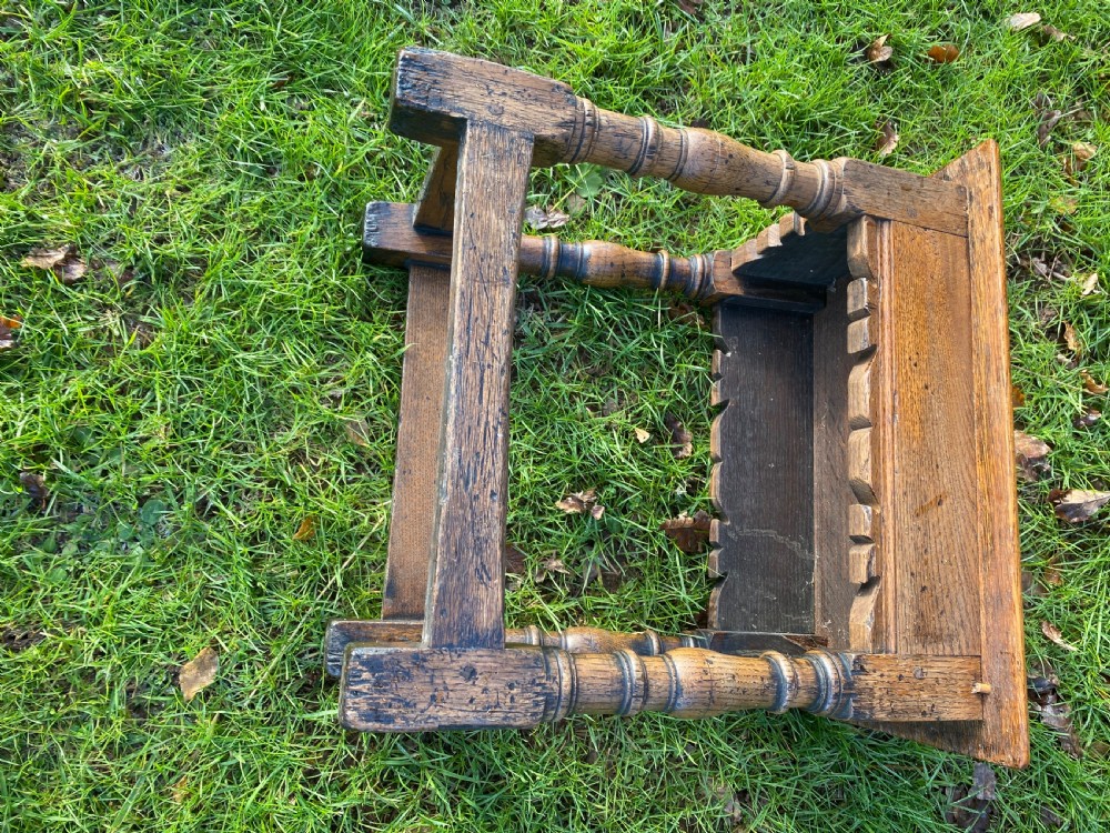 A solid oak joint stool featuring turned legs, lower perimeter stretchers, a shaped frieze apron, and a rectangular seat top. View VIII