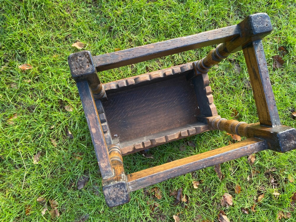 A solid oak joint stool featuring turned legs, lower perimeter stretchers, a shaped frieze apron, and a rectangular seat top. View IX