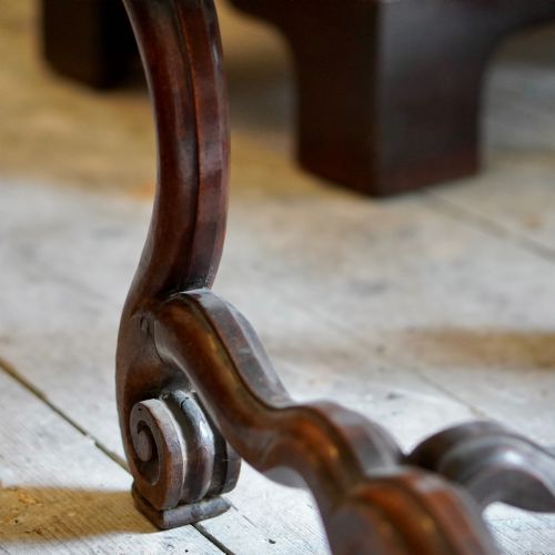 fig 5. A pair of late 19th-century French walnut side chairs with high upholstered backs in a leafy green tapestry fabric and carved curved legs.