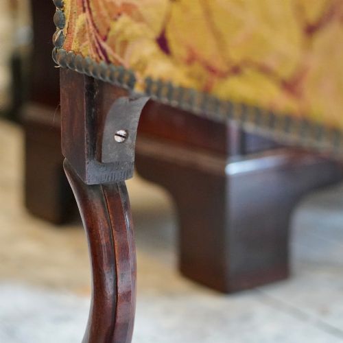 fig 6. A pair of late 19th-century French walnut side chairs with high upholstered backs in a leafy green tapestry fabric and carved curved legs.