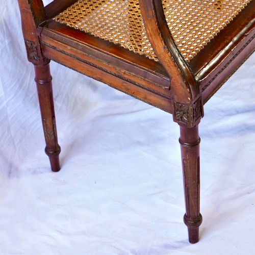 fig 6. A matching pair of 19th-century Regency style mahogany armchairs featuring carved lyre back splats and woven cane seats.