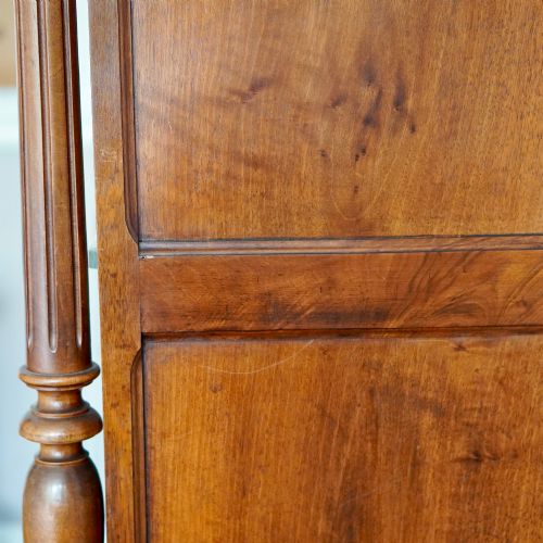 fig 4. A tall 19th-century Continental open wooden bookcase featuring an ornate carved pediment, fluted side columns, panelled back, and multiple adjustable shelves.