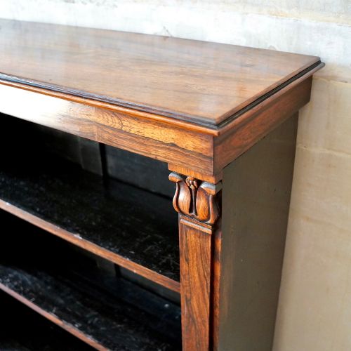 fig 5. An antique William IV rosewood open bookcase featuring two adjustable shelves, a solid plinth base, and carved scroll capitals atop side pilasters.
