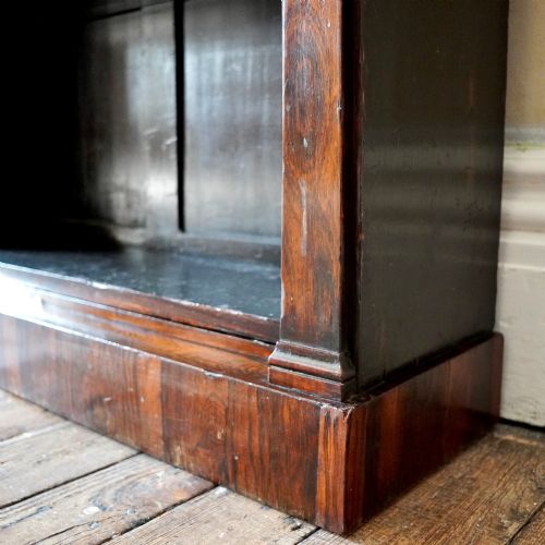 fig 7. An antique William IV rosewood open bookcase featuring two adjustable shelves, a solid plinth base, and carved scroll capitals atop side pilasters.