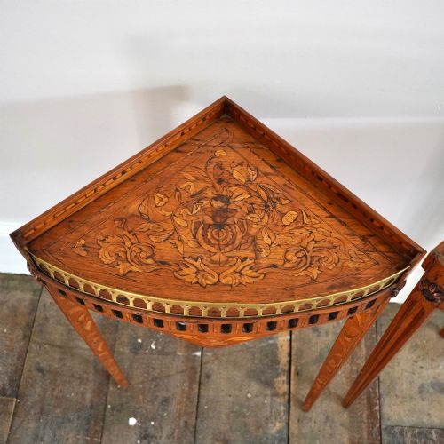fig 2. A pair of 18th-century triangular corner tables featuring detailed floral marquetry top surfaces, pierced friezes, tapering legs, and brass galleries.