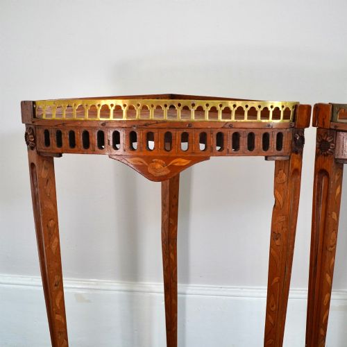fig 4. A pair of 18th-century triangular corner tables featuring detailed floral marquetry top surfaces, pierced friezes, tapering legs, and brass galleries.