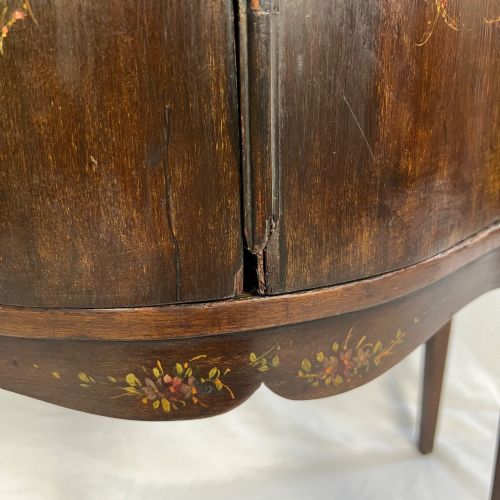 fig 3. A dark mahogany serpentine-front side cabinet with hand-painted floral swags and figurative door panel vignettes resting on slender square tapered legs.