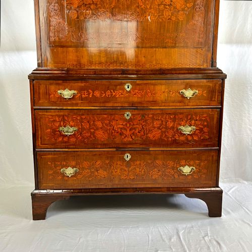 fig 2. A tall Georgian walnut escritoire bureau featuring floral marquetry inlay on the fall-front flap and lower drawers with brass drop handles.