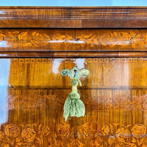 fig 3. A tall Georgian walnut escritoire bureau featuring floral marquetry inlay on the fall-front flap and lower drawers with brass drop handles.