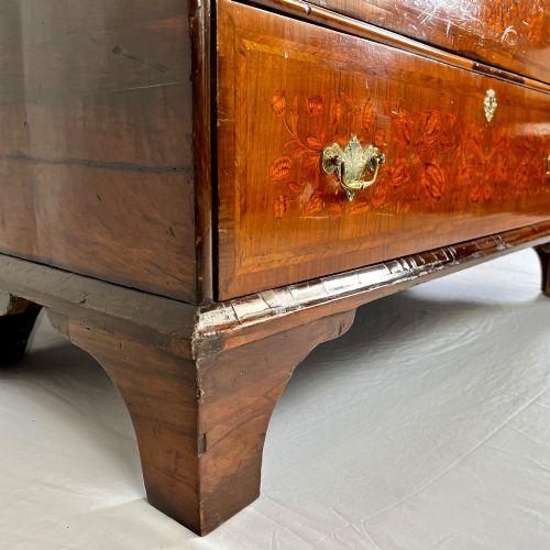 fig 4. A tall Georgian walnut escritoire bureau featuring floral marquetry inlay on the fall-front flap and lower drawers with brass drop handles.