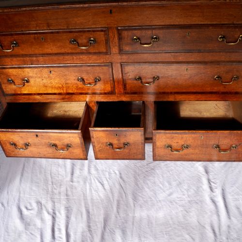 fig 5. A Georgian oak and mahogany crossbanded Lancashire mule chest with brass handles and bracket feet.
