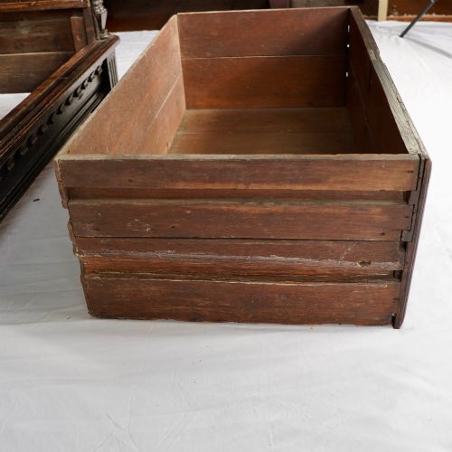 fig 5. A dark oak 17th-century style chest of drawers featuring geometric timber inlay along the top frieze, applied mouldings, and brass drop handles.