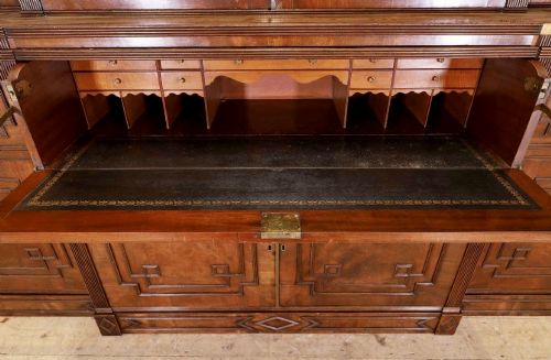 fig 4. A large George IV mahogany breakfront library bookcase featuring gothic astragal glazed upper doors above drawers and cupboard doors with geometric moulding.