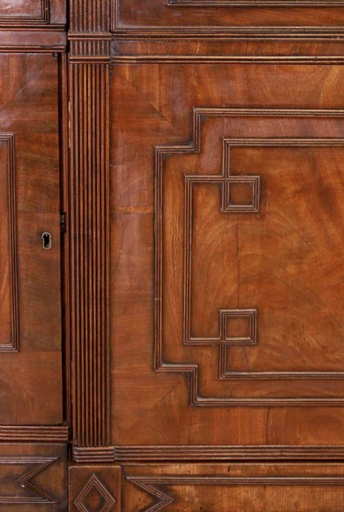fig 5. A large George IV mahogany breakfront library bookcase featuring gothic astragal glazed upper doors above drawers and cupboard doors with geometric moulding.