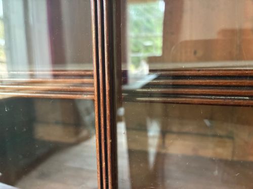 fig 8. A large George IV mahogany breakfront library bookcase featuring gothic astragal glazed upper doors above drawers and cupboard doors with geometric moulding.